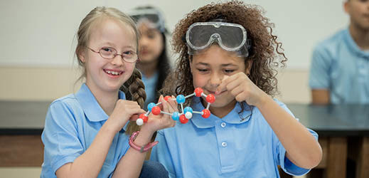 two students working with molecular model